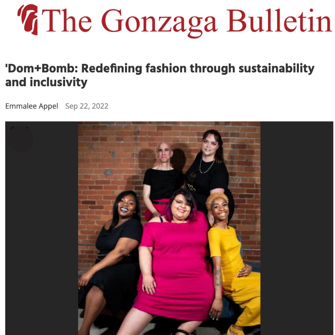 The Gonzaga Bulletin: Dom+Bomb: Redefining fashion through sustainability and inclusivity. Image of five models smiling at the camera. Three in front are sitting on a blue velvet couch. Three in back are standing against a brick wall.